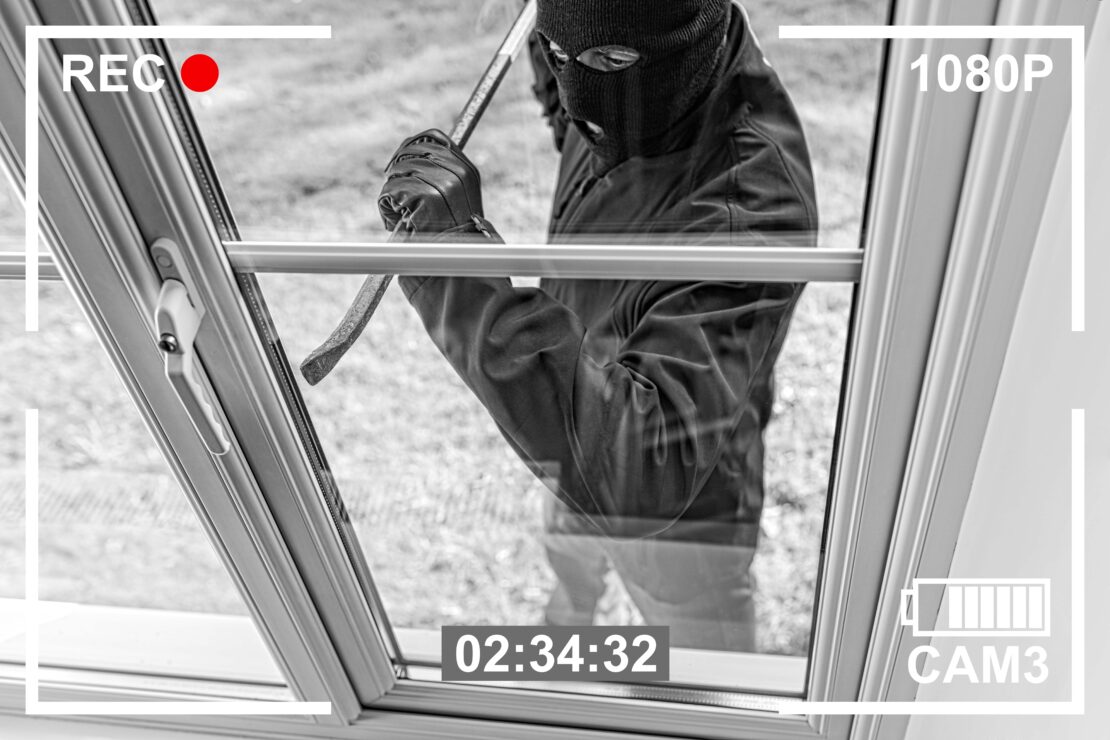 Burglar trying to get inside the house through a window