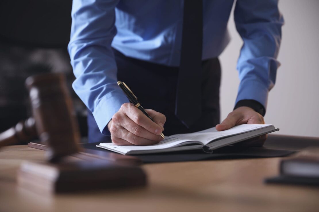 Photo of a Lawyer Signing Documents